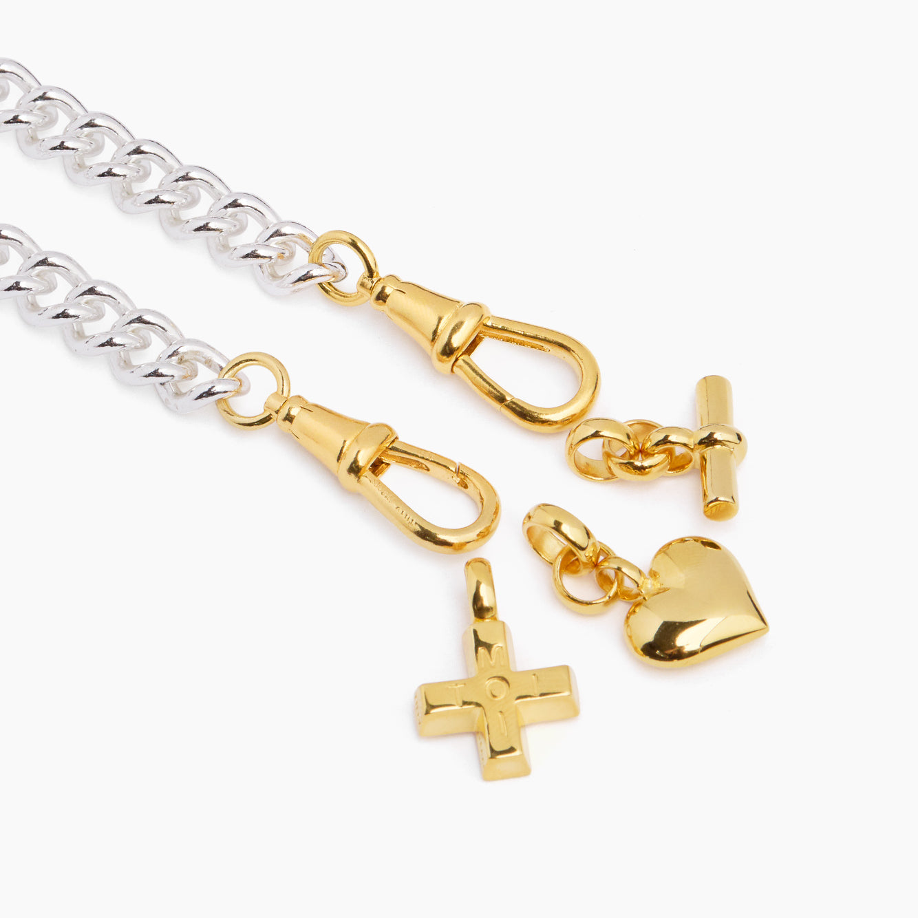 Silver chain charm bracelet with gold heart, lock, and cross dangling charms