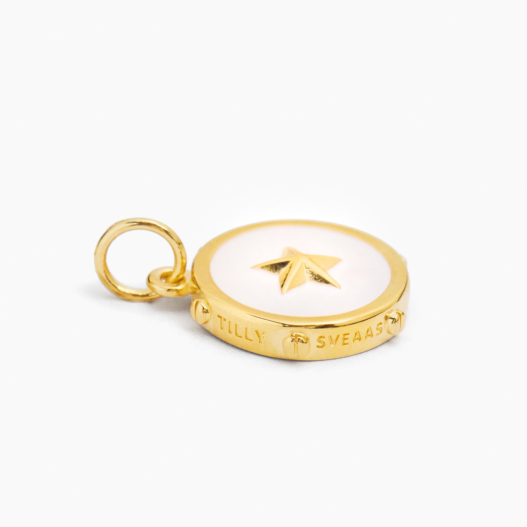 Gold-tone cream enamel disc charm with star motif and small hanging ring