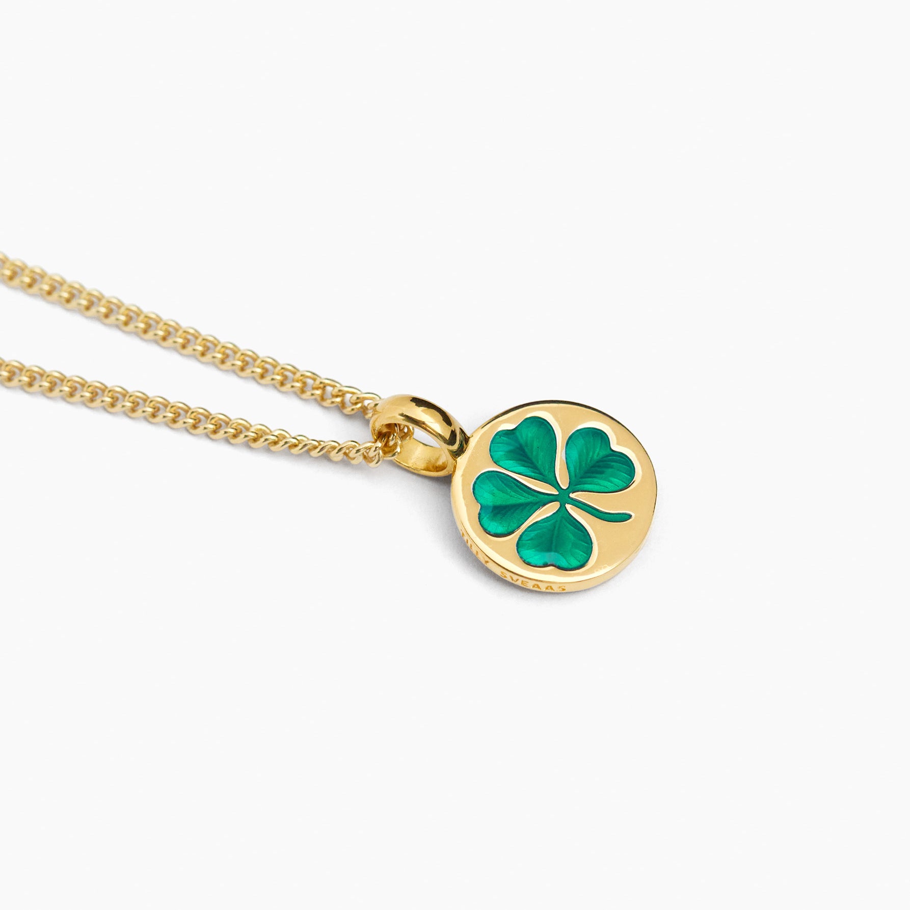 Gold clover pendant necklace with green enamel on fine curb chain