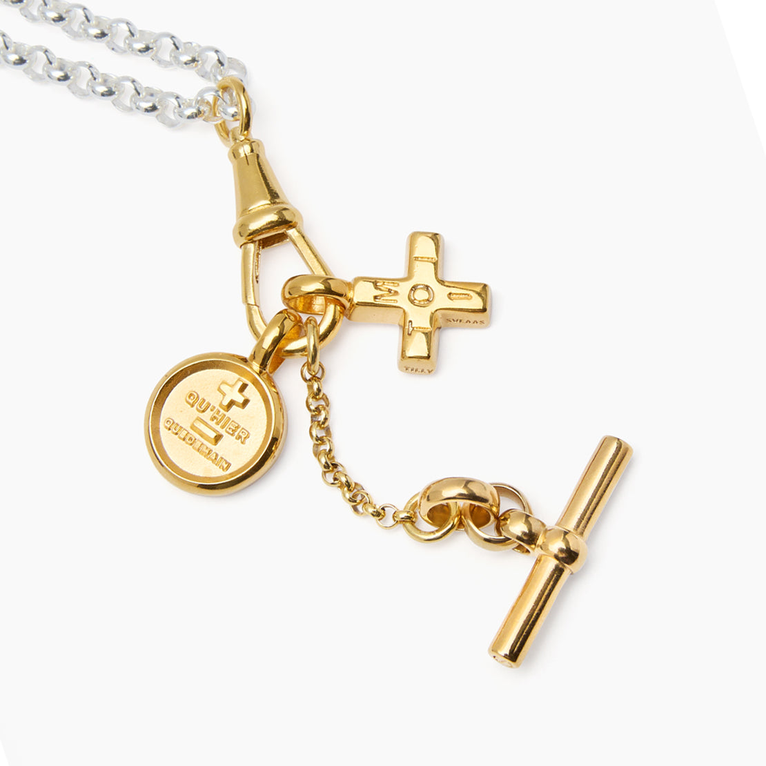 Mixed metal charm necklace with round medal and cross charms plus gold bar link detail