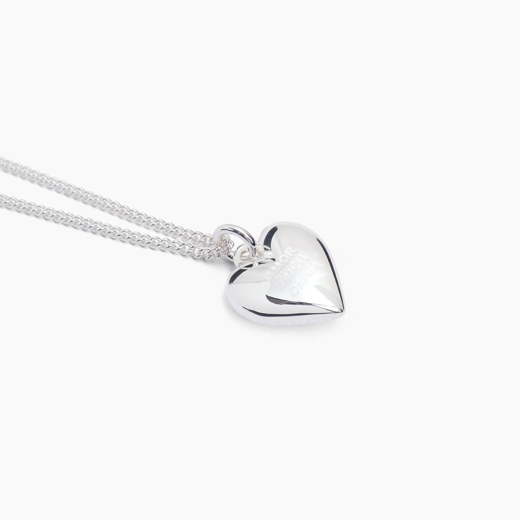 Silver heart charm necklace on fine curb chain, polished heart pendant