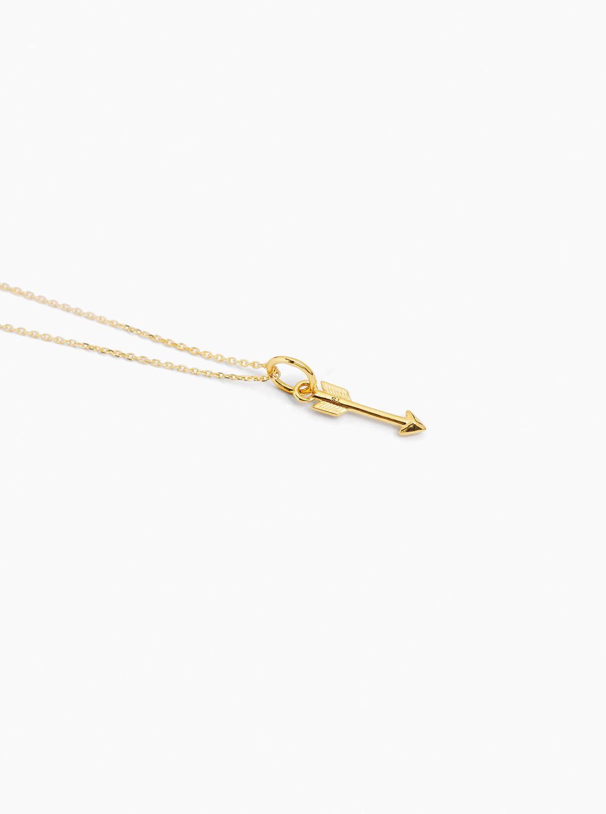 Small gold arrow pendant necklace on thin trace chain