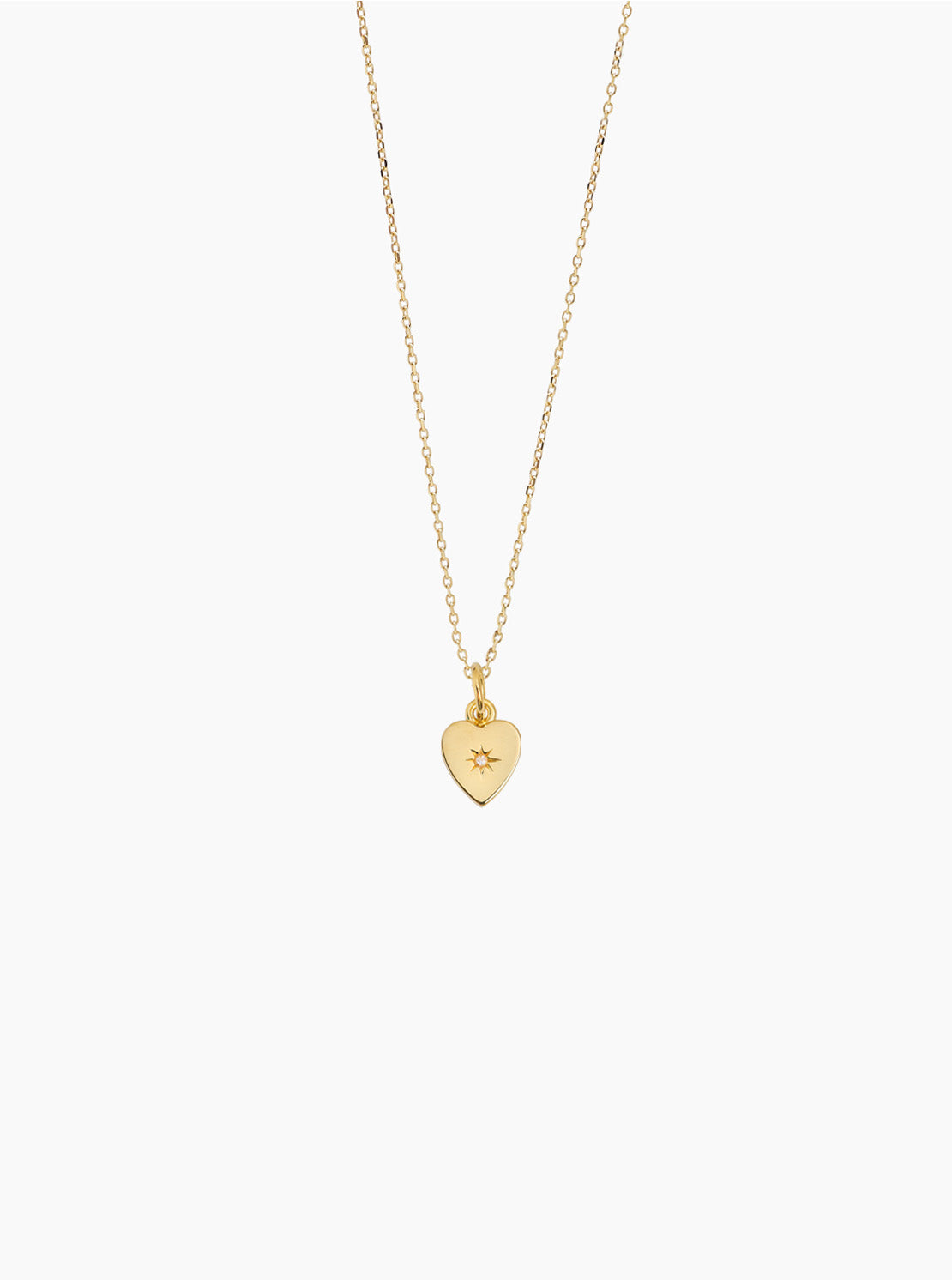Gold heart pendant necklace with trace chain and small jeweled detail
