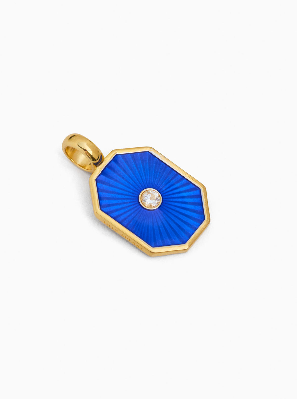 Gold-tone octagon charm with deep blue gemstone and small round clear center