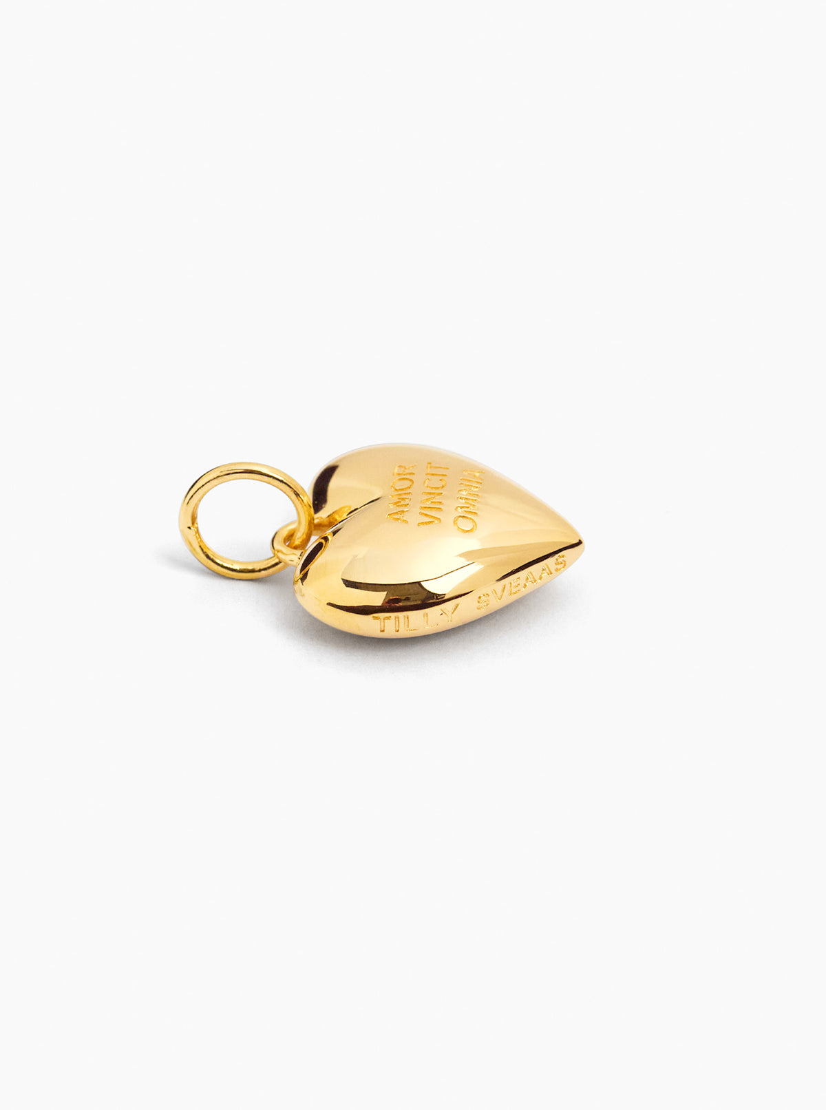Gold heart-shaped charm with attached loop ring and engraved message