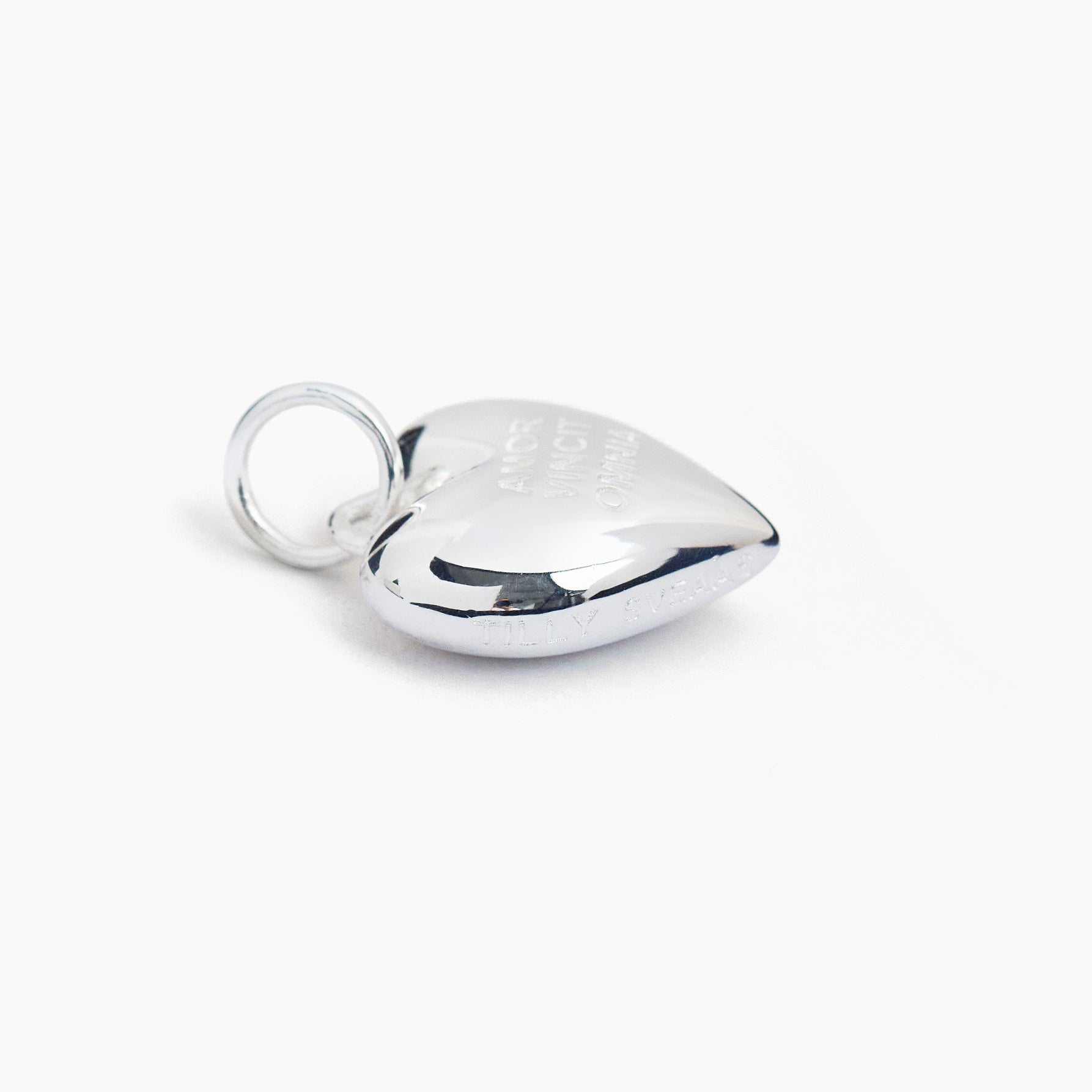 Polished silver heart charm with loop bail, raised curved top