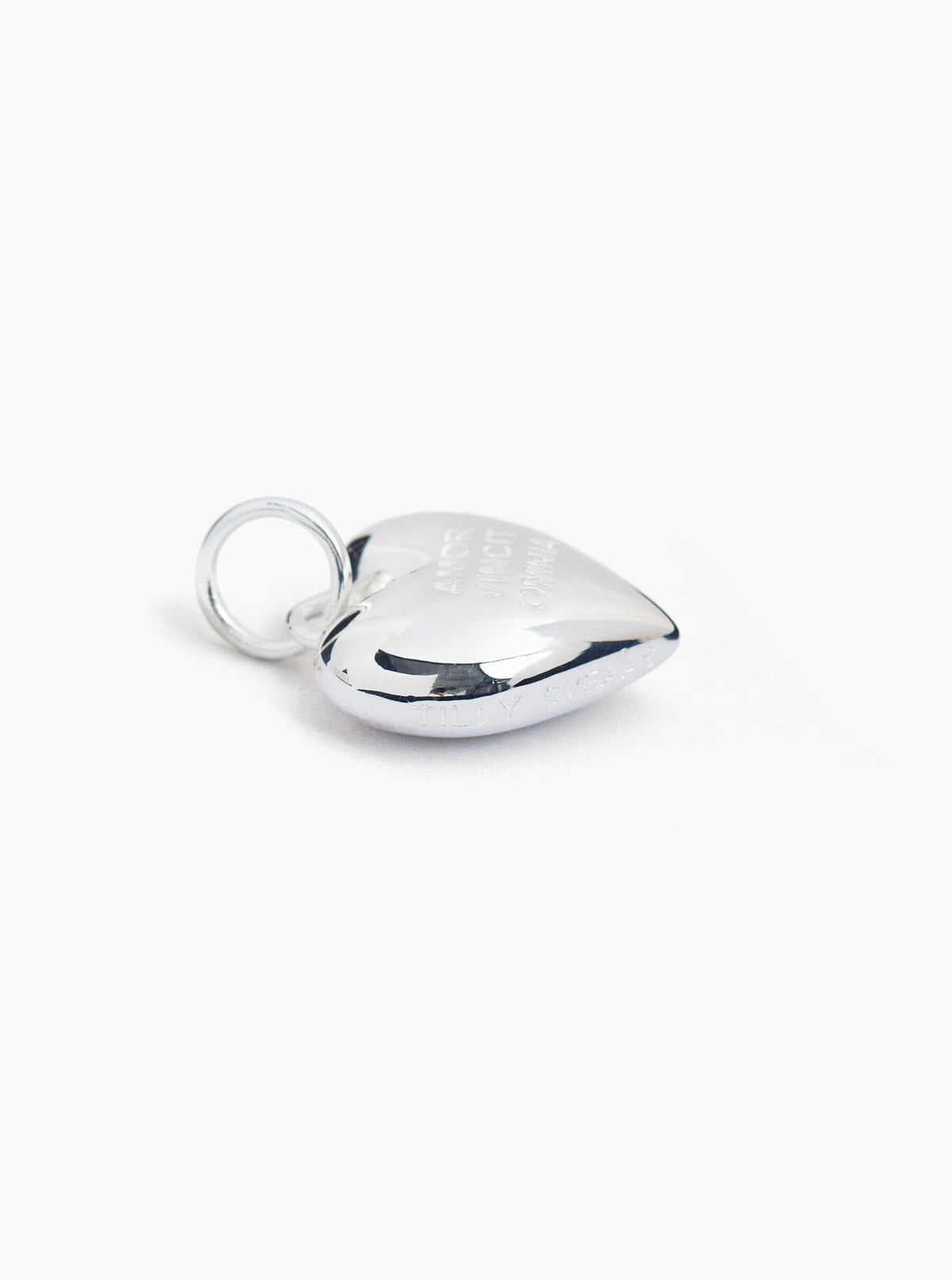 Polished silver heart charm with loop bail, raised curved top
