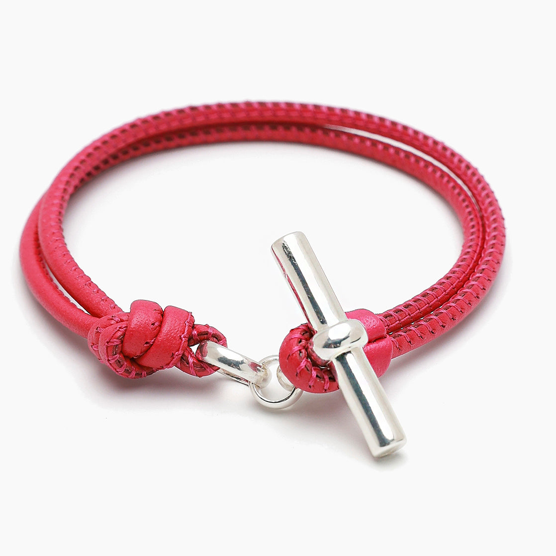 Pink leather bracelet with braided cord and silver T-bar clasp, knot detail