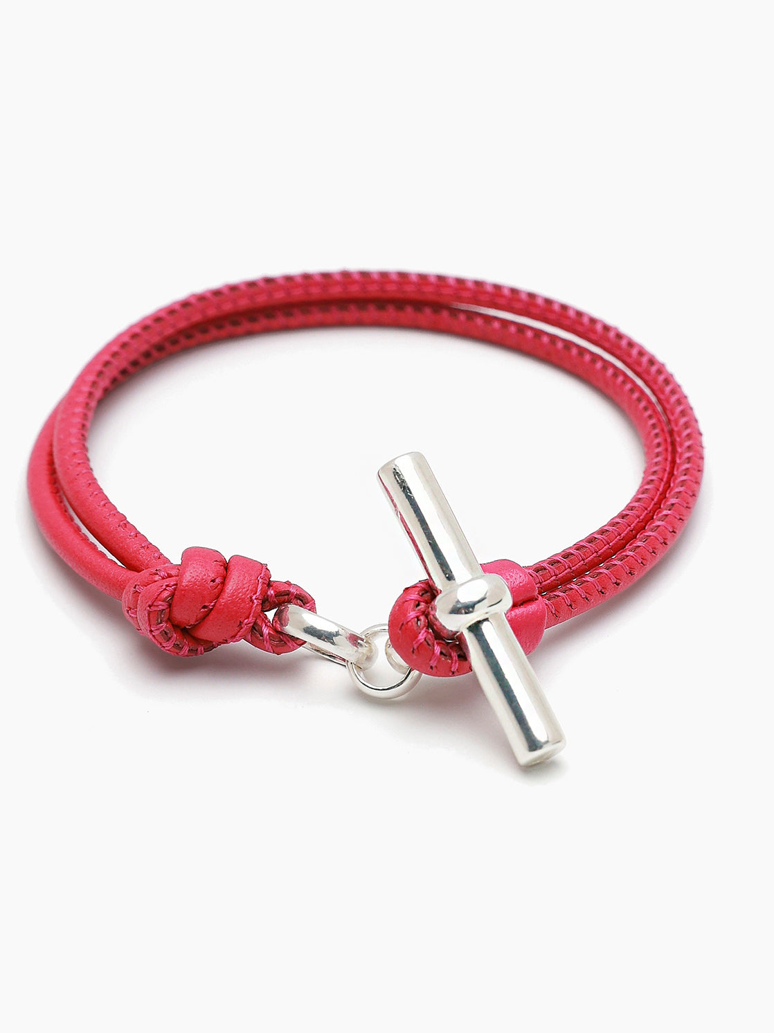 Pink leather bracelet with braided cord and silver T-bar clasp, knot detail