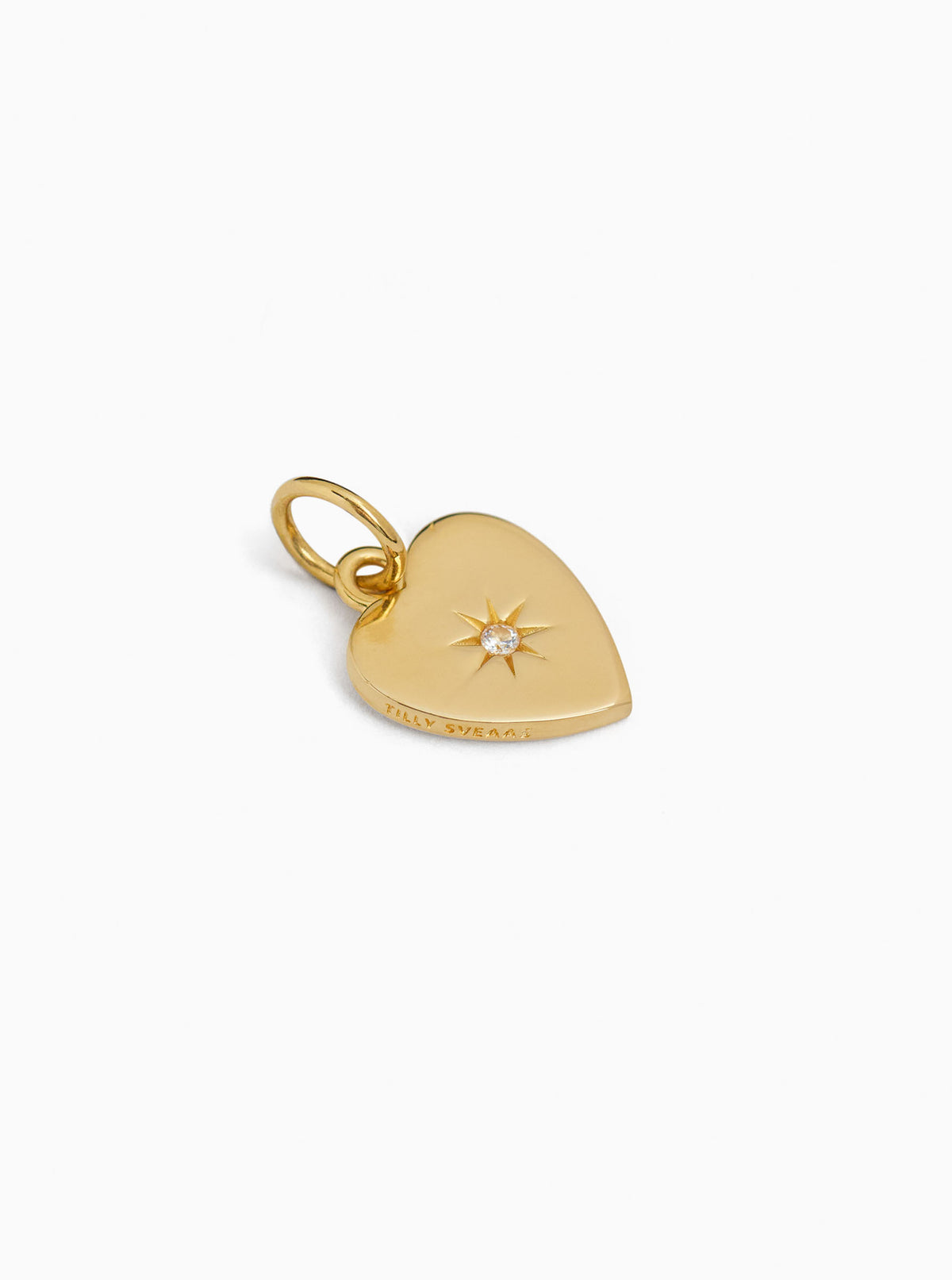 Gold-tone flat heart charm with jeweled sunburst detail and small loop