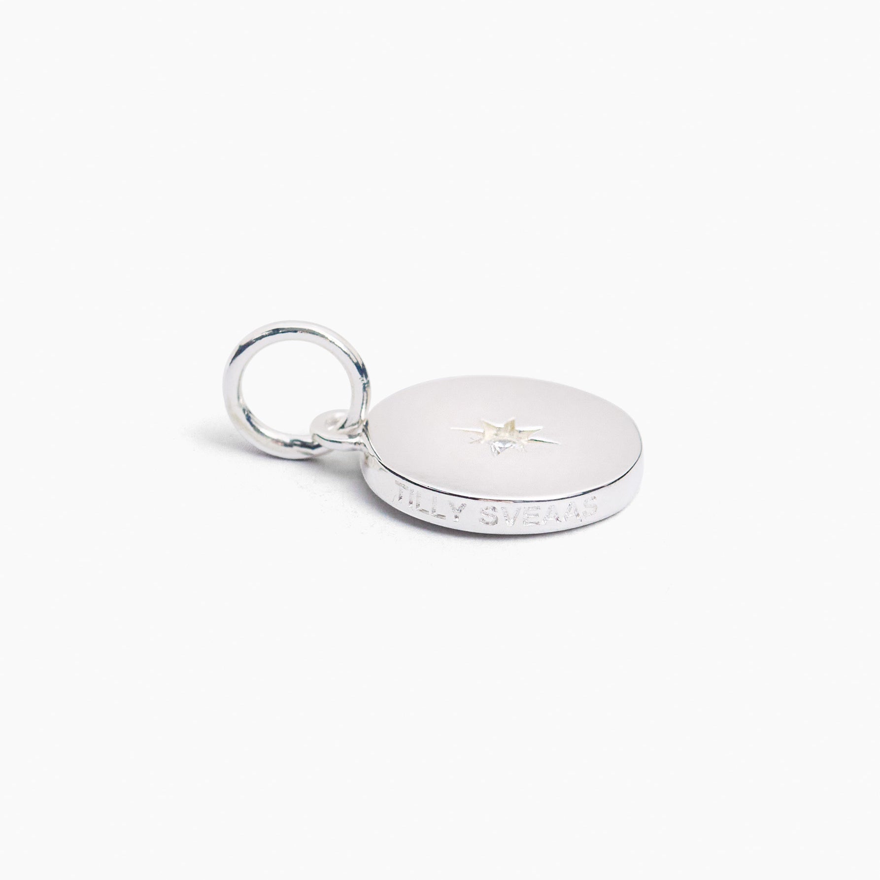 Silver disc charm with star jewel and textured edge with split ring clasp