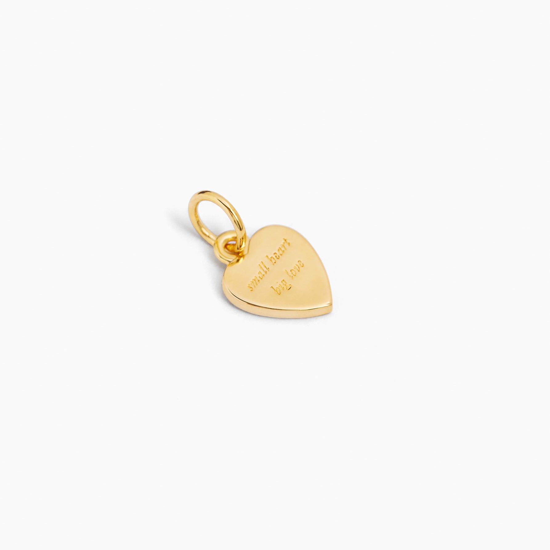 Gold-tone flat heart charm with small starburst detail and hanging loop