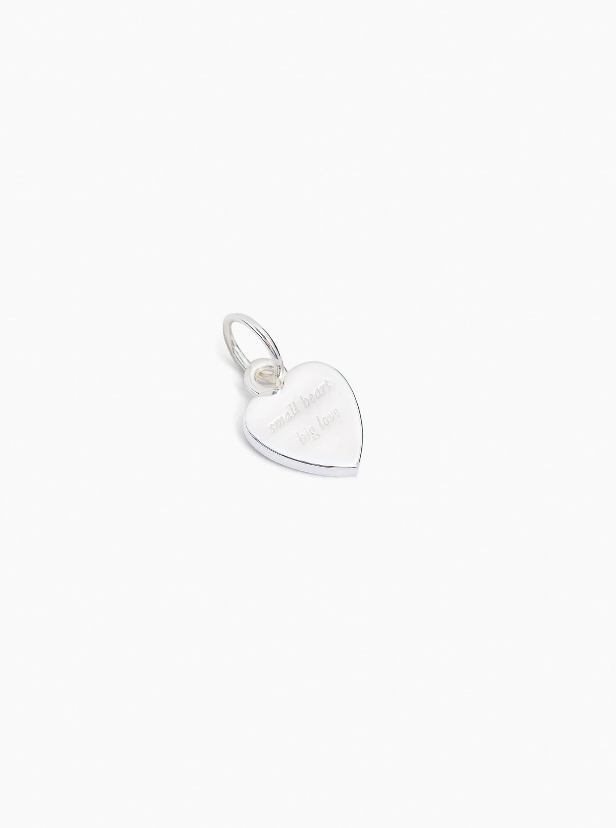 Small silver heart charm with flat back and hanging loop, jeweled detail on front
