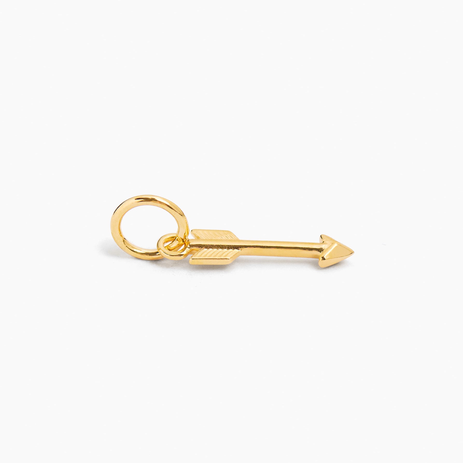 Small gold arrow pendant charm with round loop bail and engraved arrow