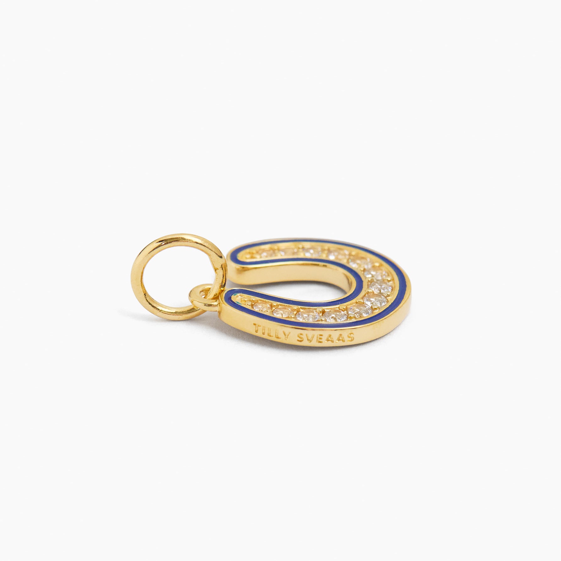 Gold horseshoe charm with blue enamel and sparkling stones, with small hanging loop