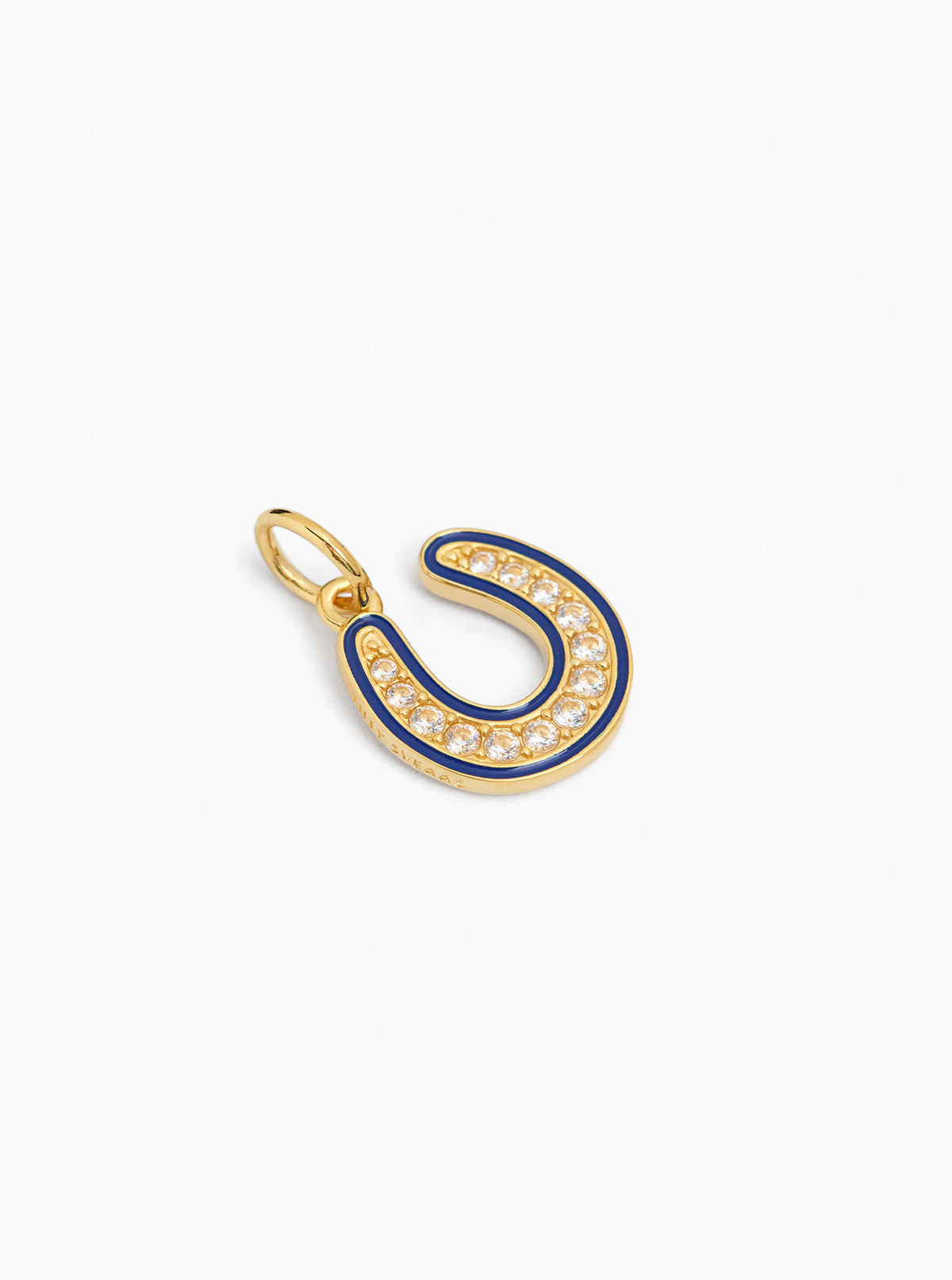 Gold horseshoe charm with blue enamel and clear stone edging, shown from an angle