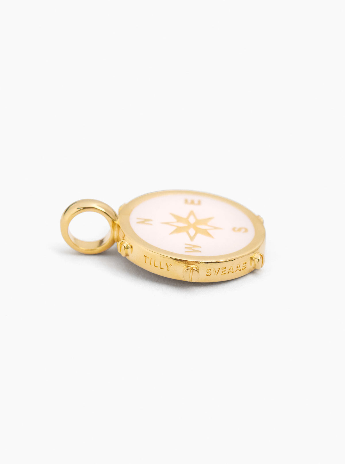 Gold-tone compass charm with cream enamel front, star icon and engraved text, loop bail