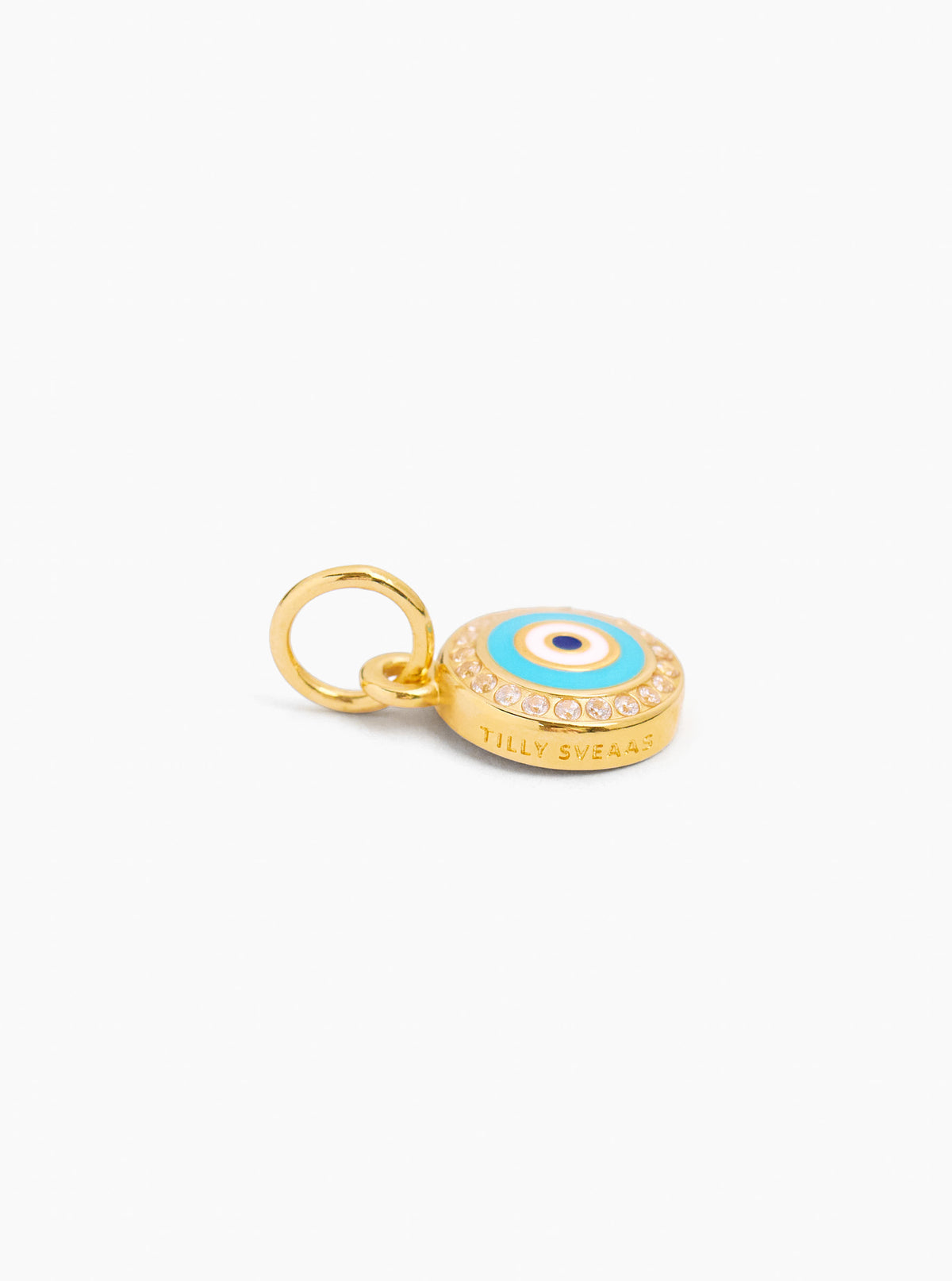 Gold evil eye disc charm with blue enamel center and ring bail; engraved band visible