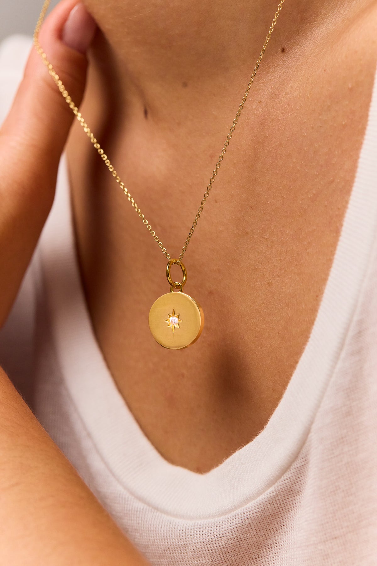 Gold round disc pendant on fine trace chain, round charm with jewel detail
