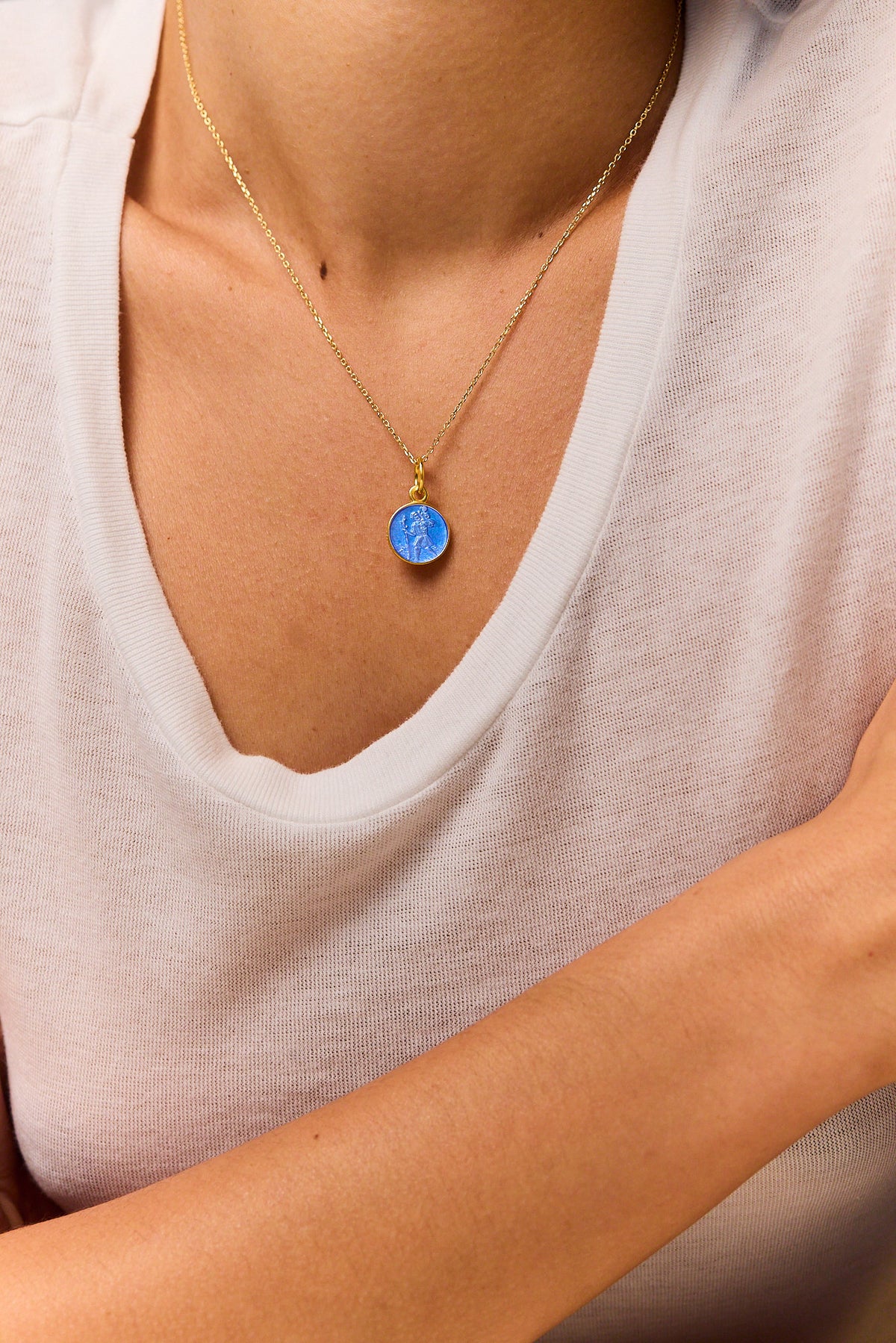 Blue St Christopher medallion pendant on gold trace chain necklace