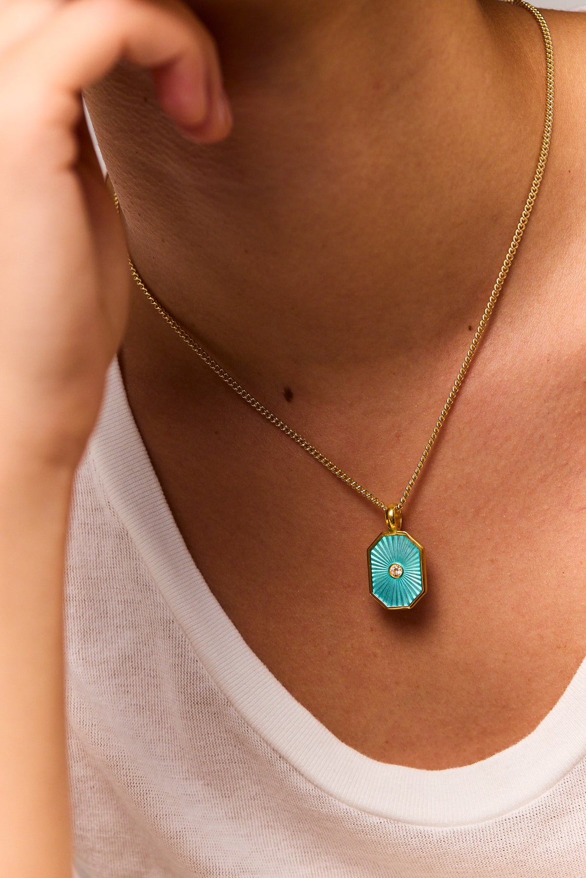 Gold-tone curb chain necklace with turquoise octagon pendant and round center gem