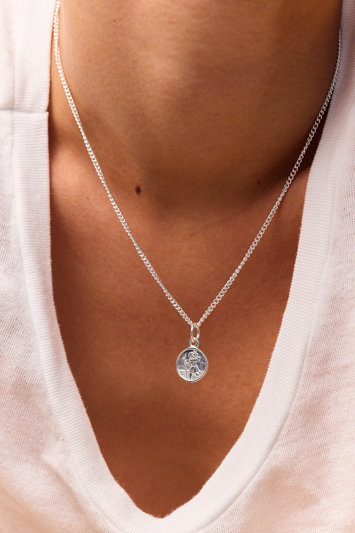Sterling silver pendant necklace with St Christopher circular medallion on curb chain