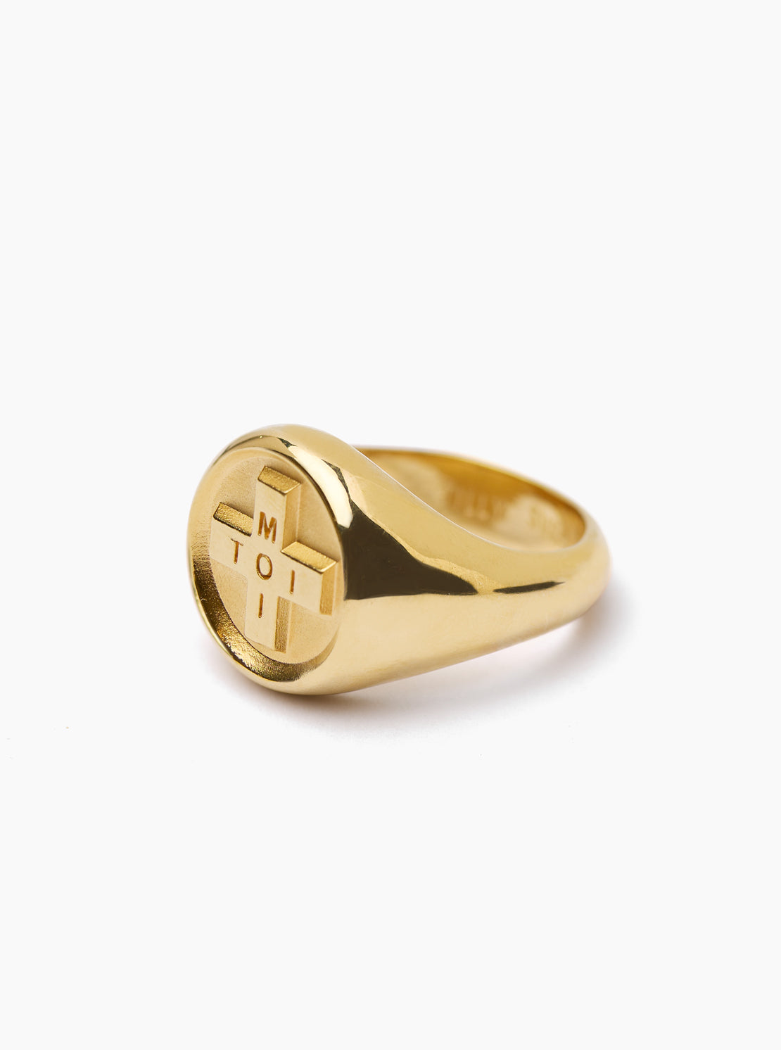 Gold ring with a circular design on a white background
