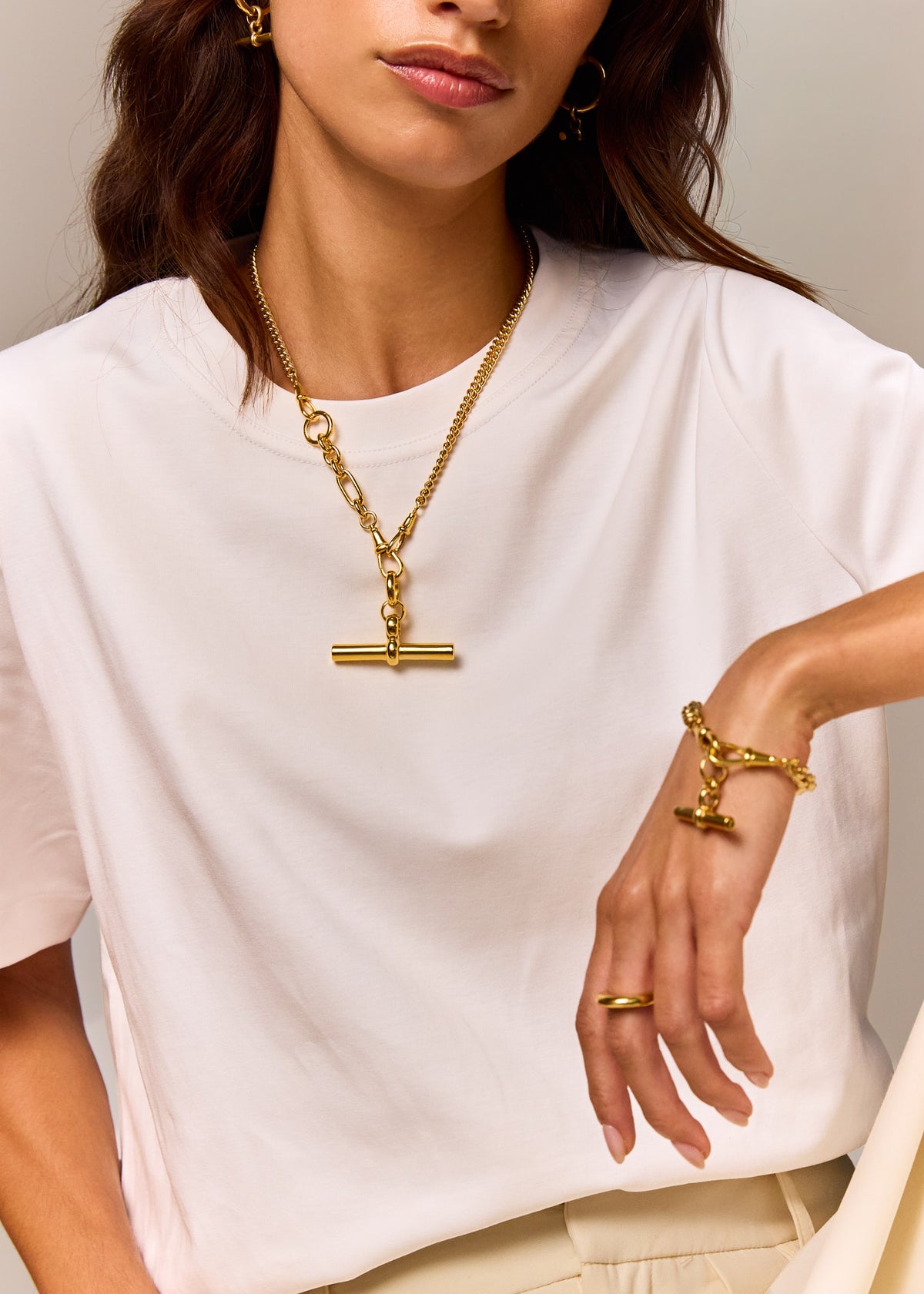 Gold-tone chain necklace and matching T-bar bracelet, worn