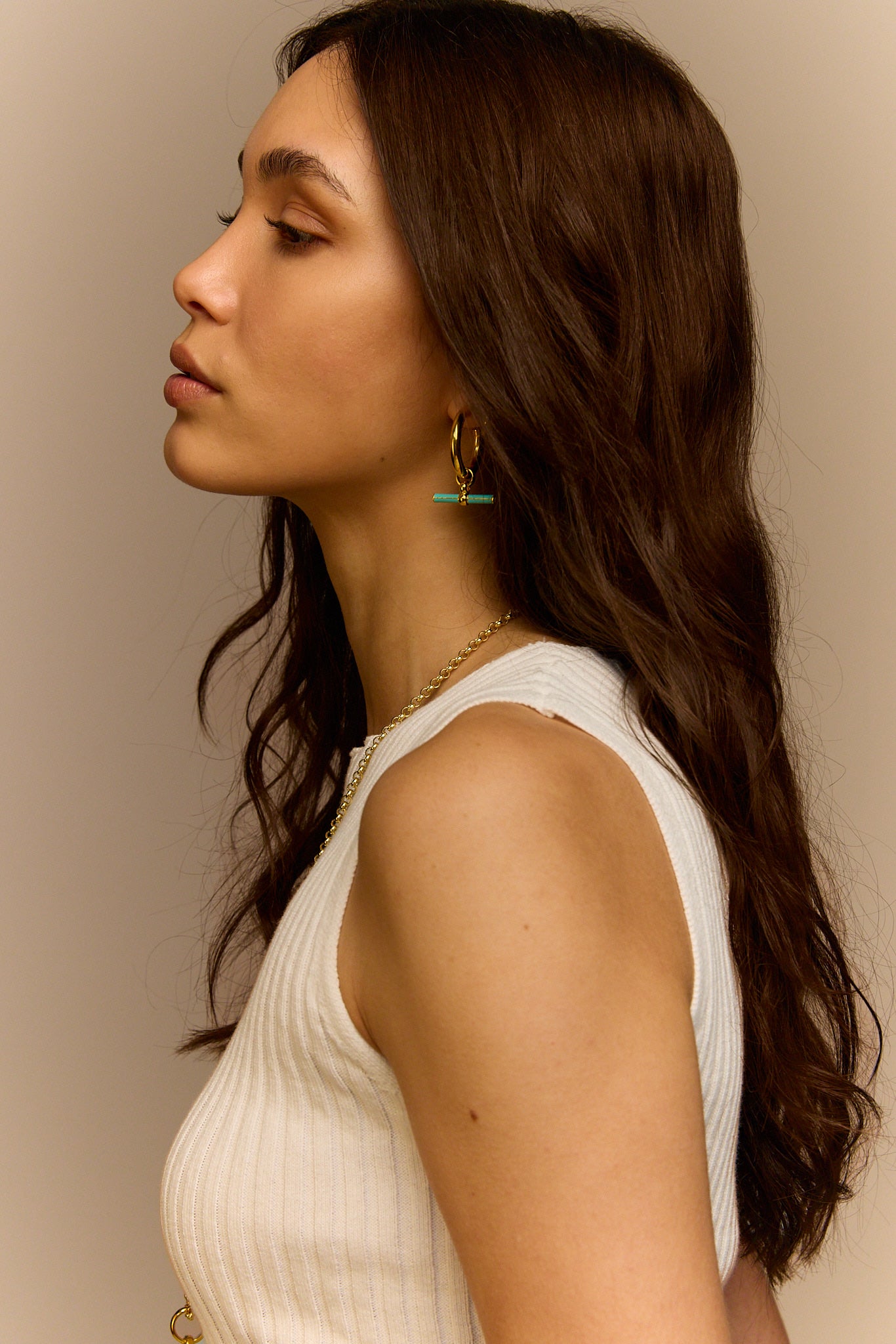 Gold T-bar earrings with mint enamel bar charms, side view