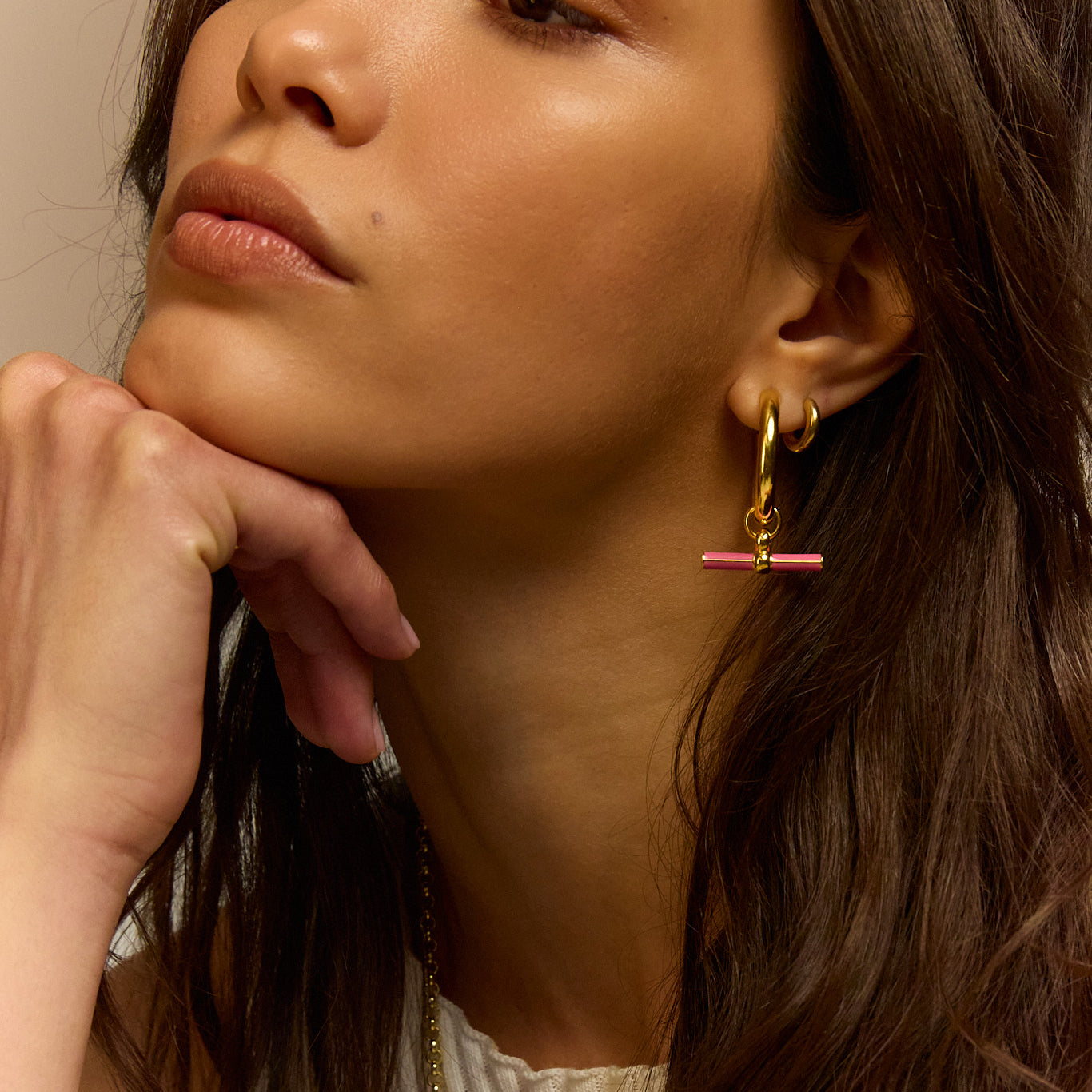 Gold hoop earrings with pink enamel bar and charm
