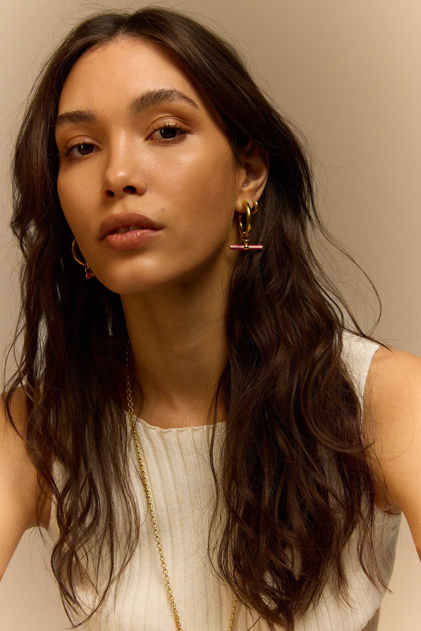 Gold hoop earrings with pink enamel bar charm
