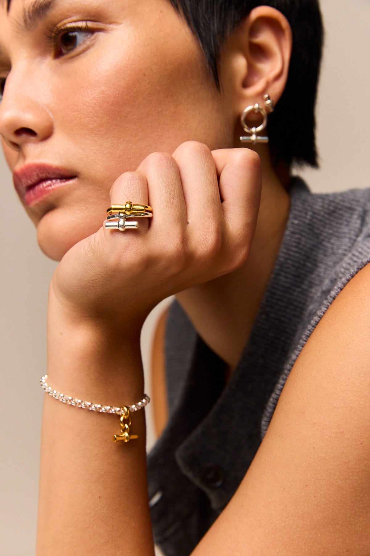 Silver chain bracelet with small gold T-bar charm and toggle clasp