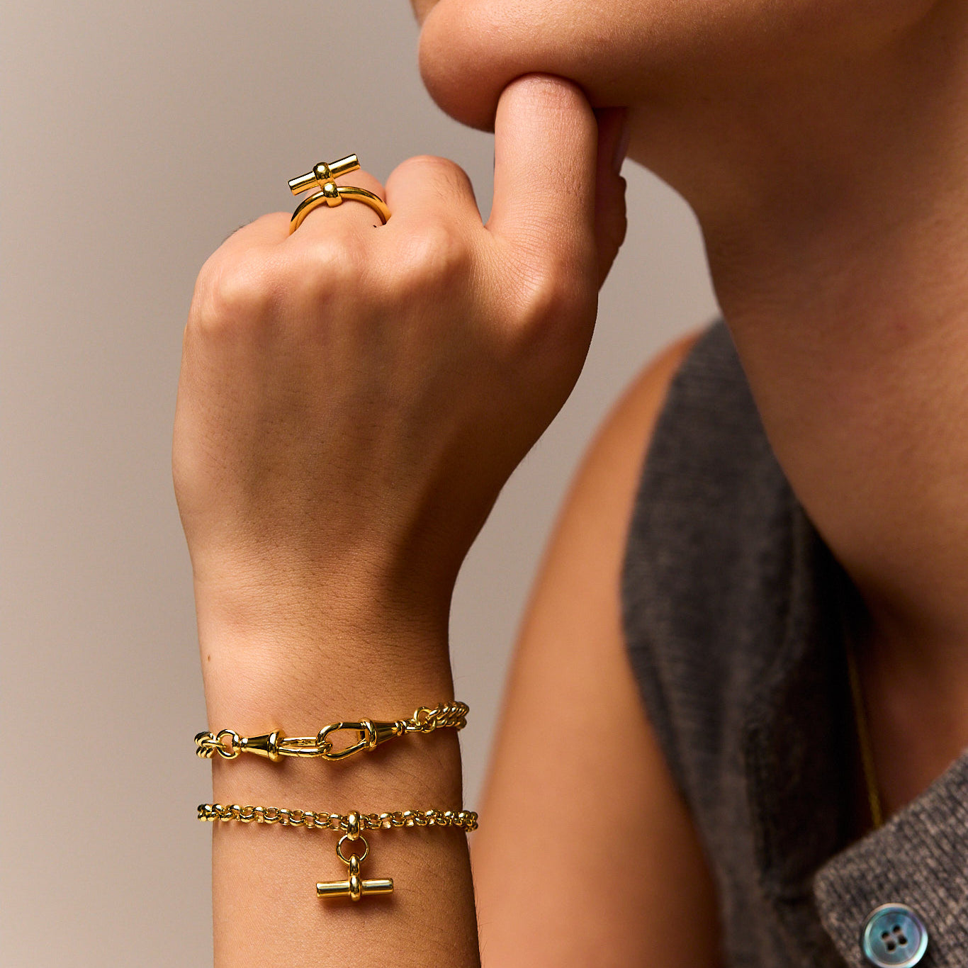 Gold curb bracelet with lobster clasp, shown worn on the wrist