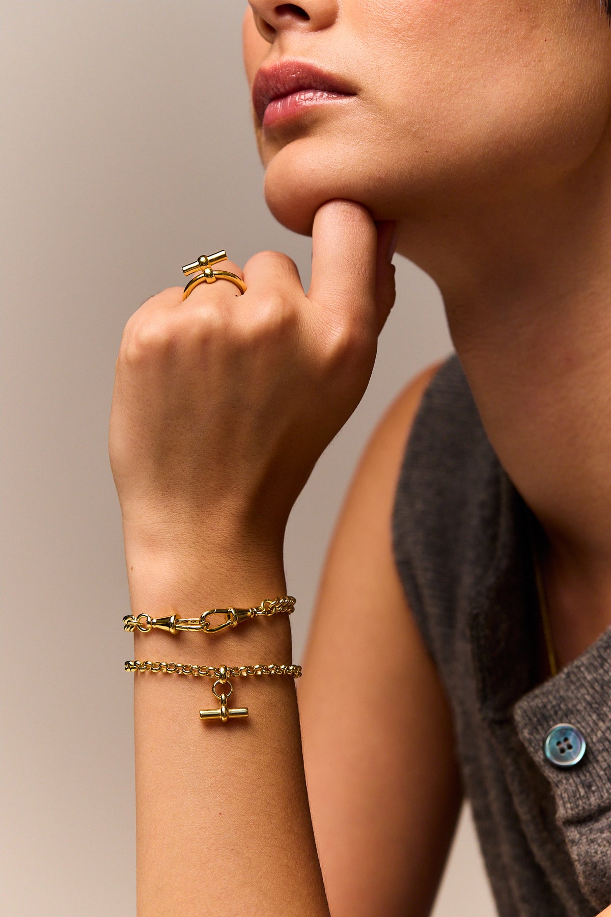 Gold curb bracelet with lobster clasp, shown worn on the wrist