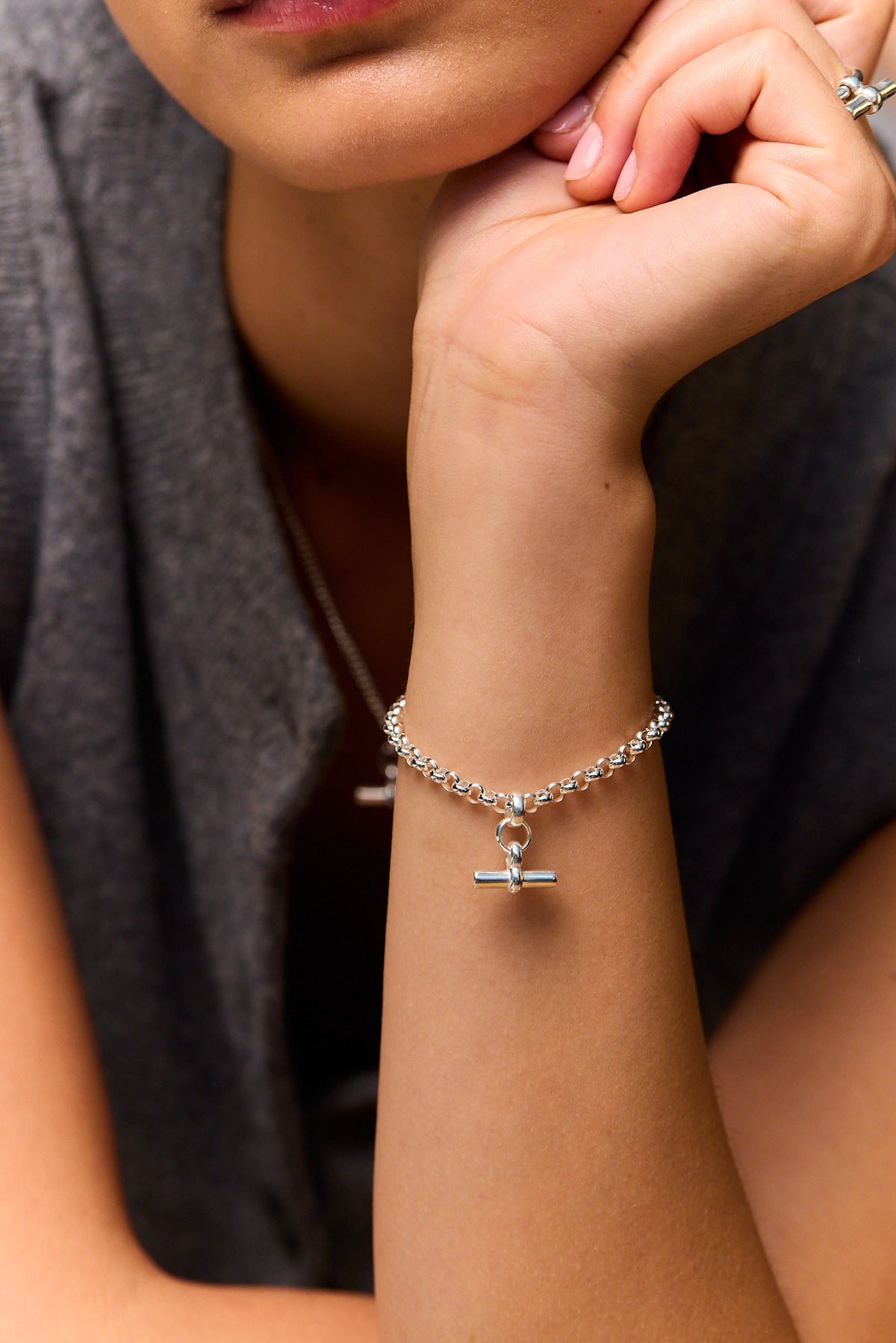 Silver chain bracelet with mini T-bar charm, worn on wrist