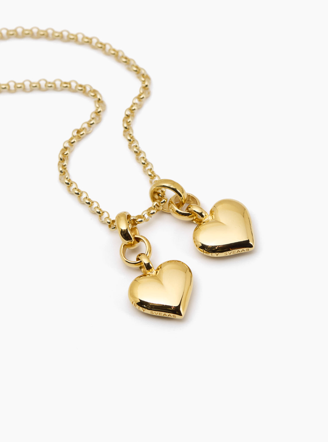 Gold necklace with heart-shaped pendants on a white background