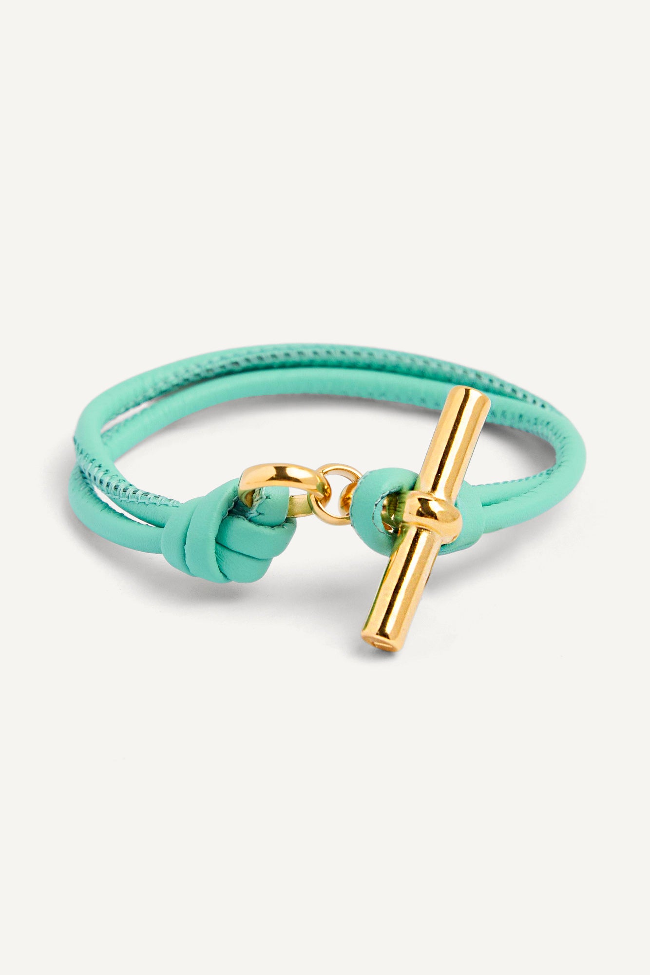 Aquamarine leather bracelet with gold T-bar charm on braided strap, knot