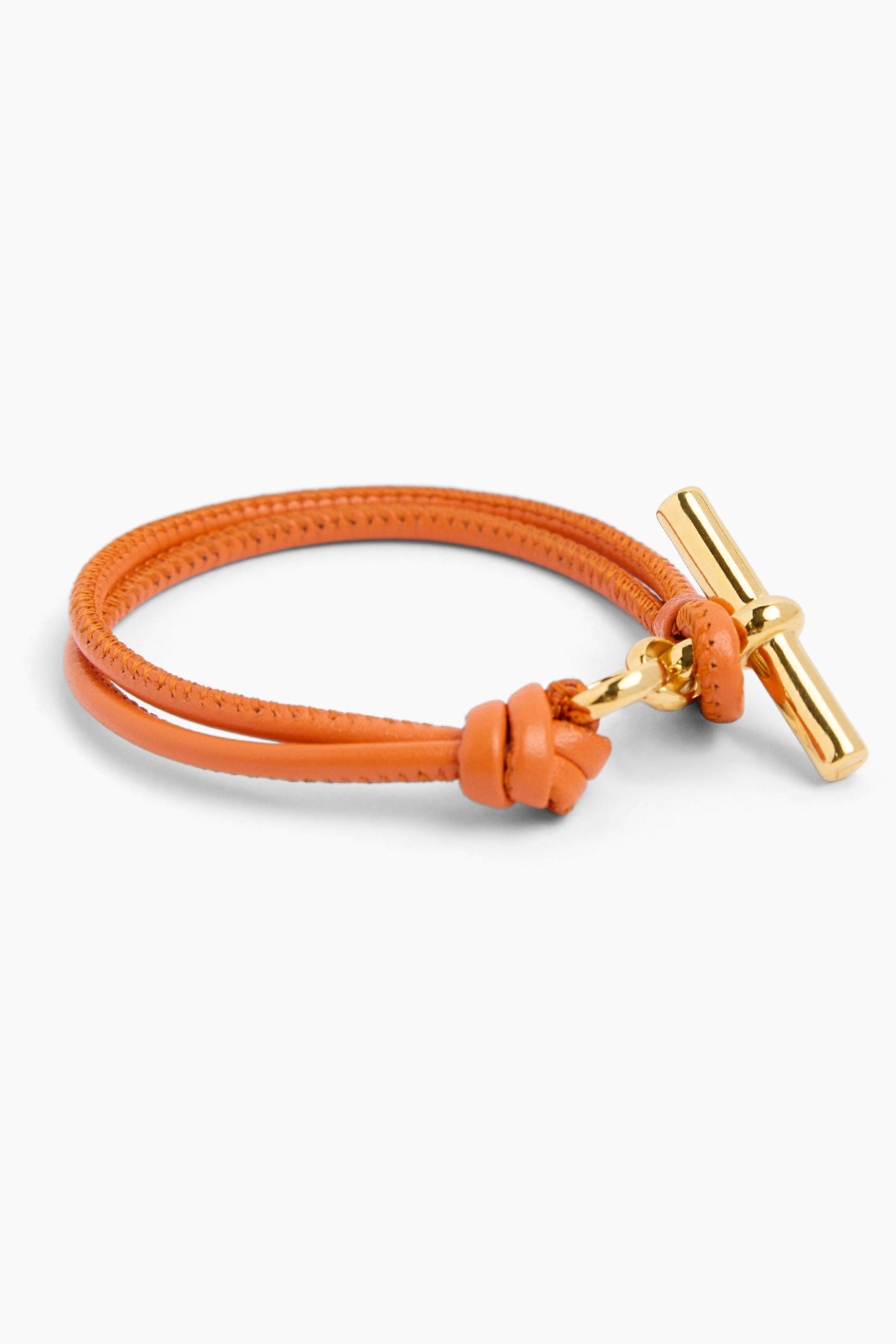 Orange leather bracelet with gold T-bar charm and twisted knot closure