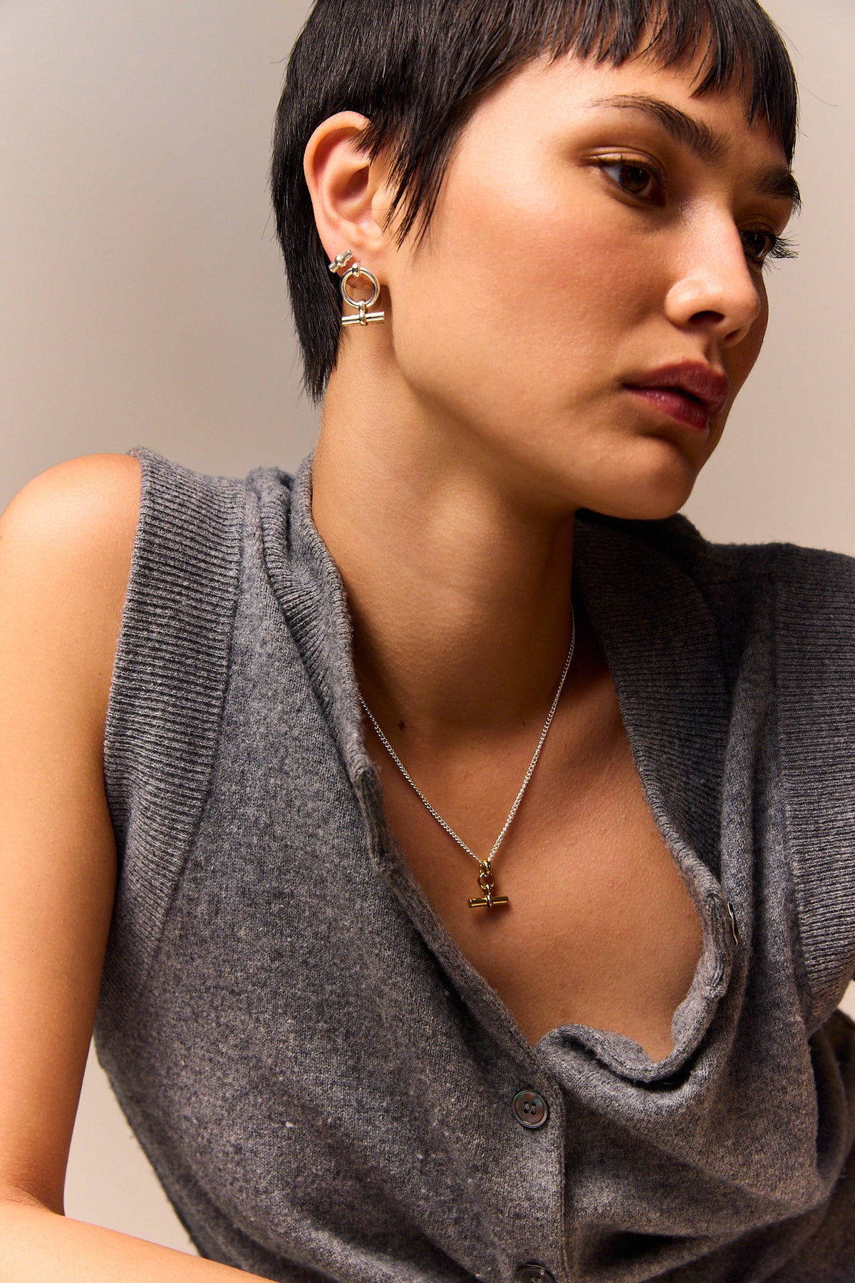 Silver T-bar stud earrings worn on ear