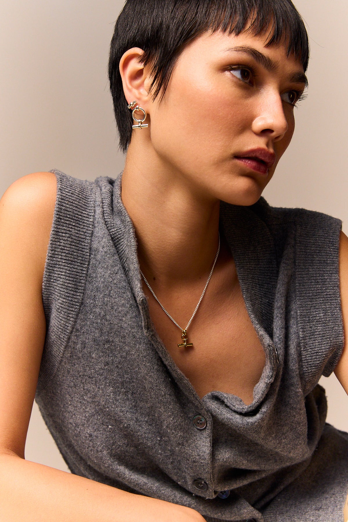 Mini T-bar eternity stud earring on ear, circular hoop with bar detail