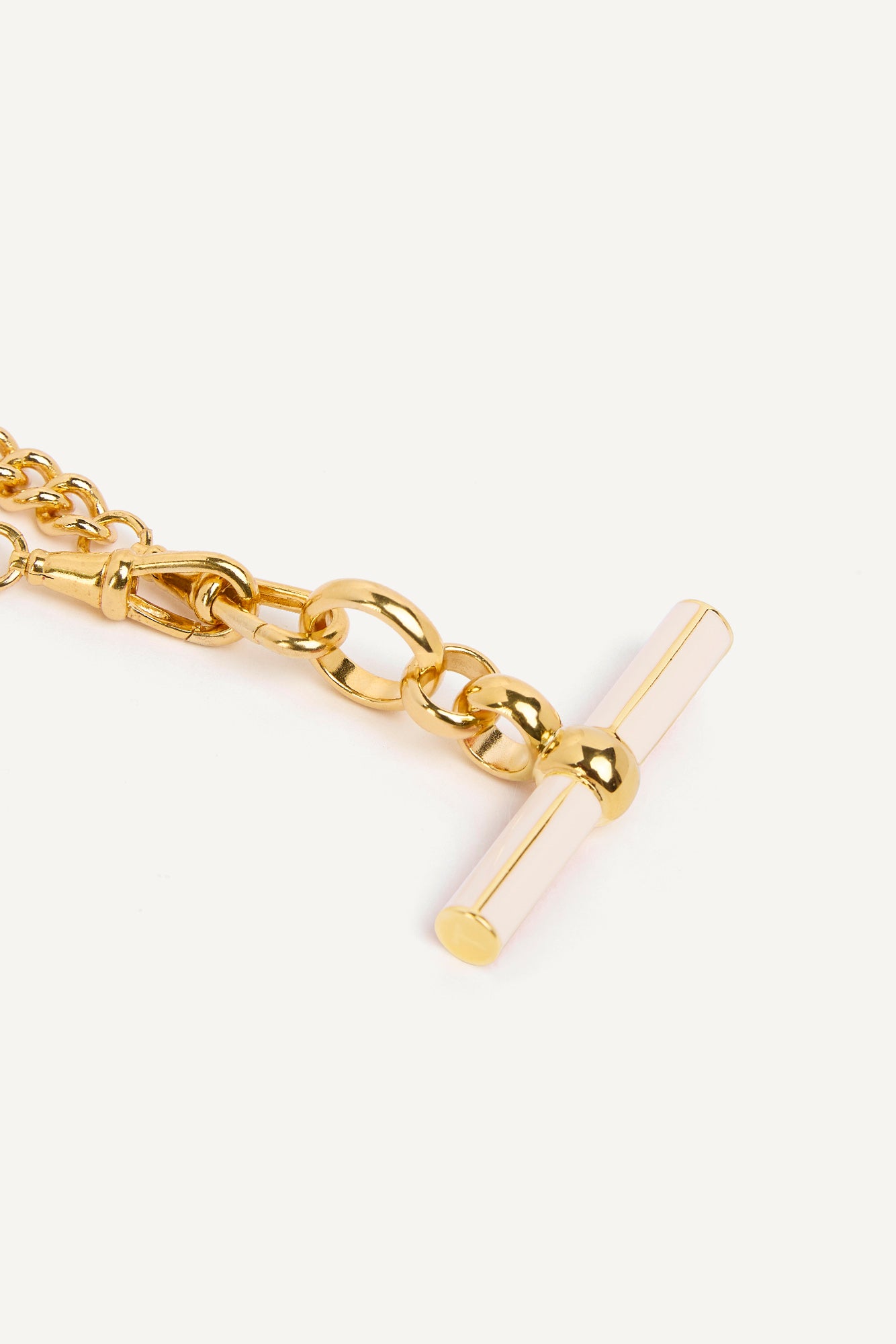 Gold curb chain with cream enamel T-bar charm