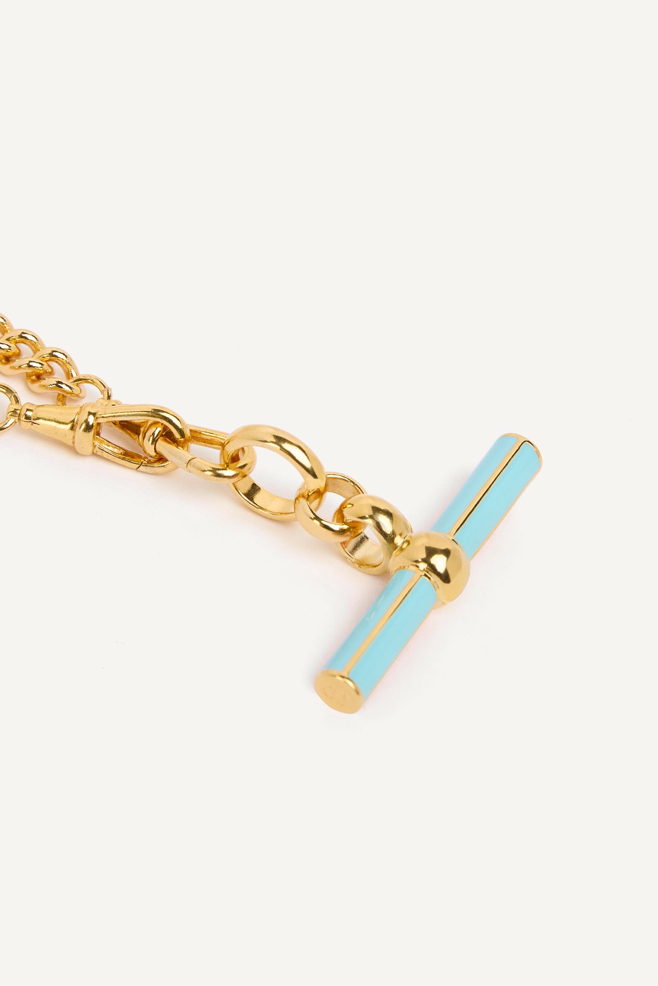 Gold curb chain with blue enamel T-bar charm and clasp detail