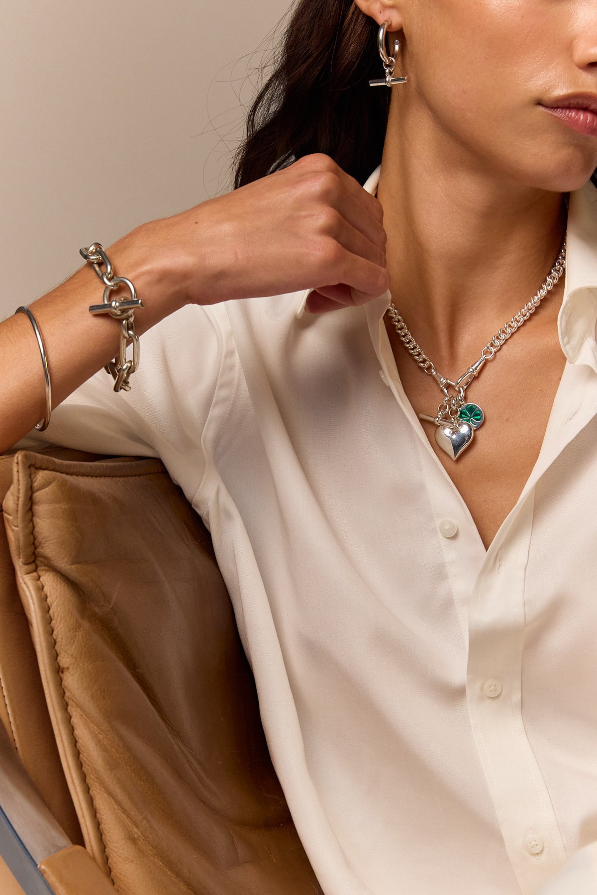 Heart charm necklace with silver chain and green clover heart pendant, close-up
