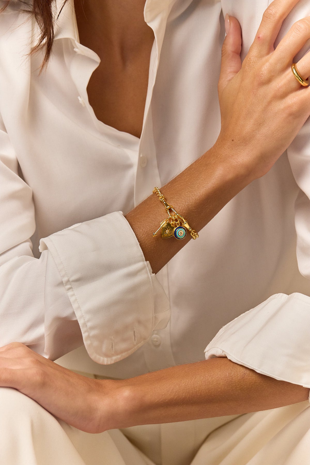 Gold chain charm bracelet with blue eye and star key charm