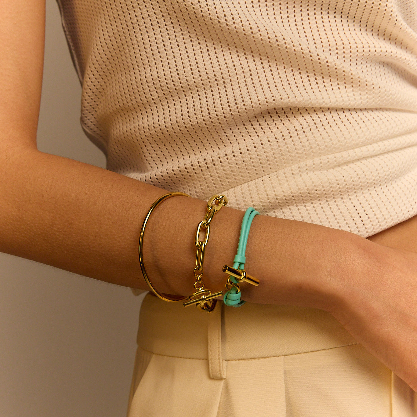 Aquamarine leather bracelet with gold T-bar charm and ring clasp detail