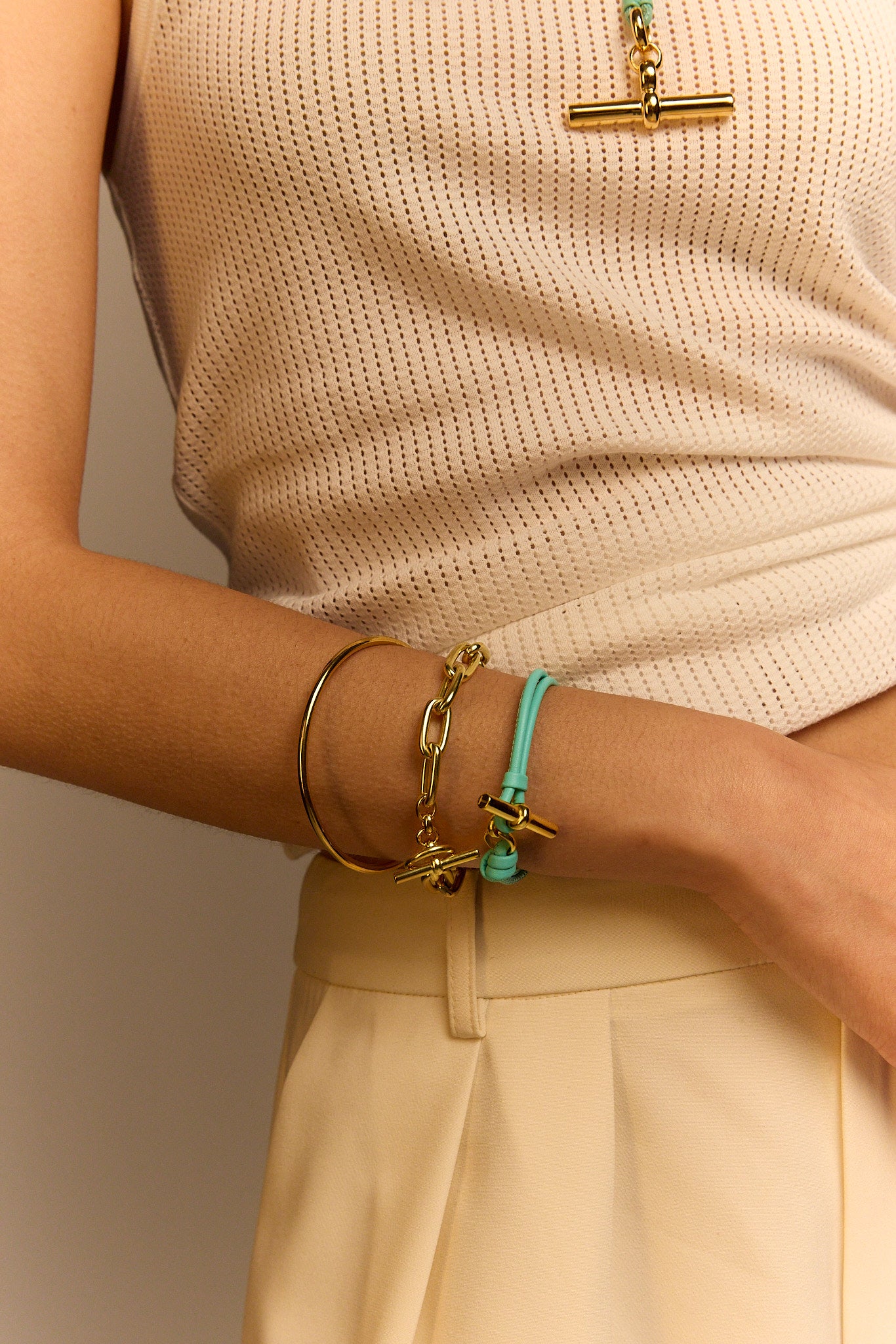 Aquamarine leather bracelet with gold T-bar charm and ring clasp detail